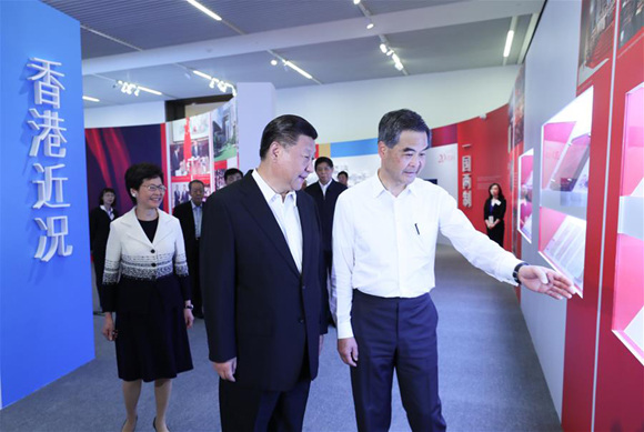 Chinese President Xi Jinping (L, front), accompanied by Leung Chun-ying (R, front), chief executive of Hong Kong Special Administrative Region, visits an exhibition profiling the achievements made in Hong Kong since its return to the motherland in 1997 in Beijing, capital of China, June 26, 2017. (Xinhua/Lan Hongguang)