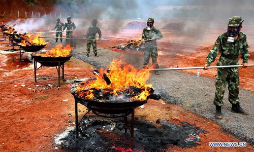 Officers burn confiscated drugs in Mangshi City, capital of Dehong Dai and Jingpo Autonomous Prefecture in southwest China's Yunnan Province, June 26, 2017. A total of 5.635 tonnes of confiscated drugs were destroyed in the city on Monday, the 30th International Day Against Drug Abuse and Illicit Trafficking. (Photo/Xinhua)
