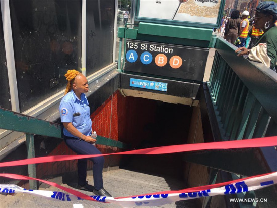 A staff member of Metropolitan Transportation Authority (MTA) stands guard at the entrance of 125 Street Station in Harlem, New York, the United States on June 27, 2017. (Xinhua/Yang Shilong)