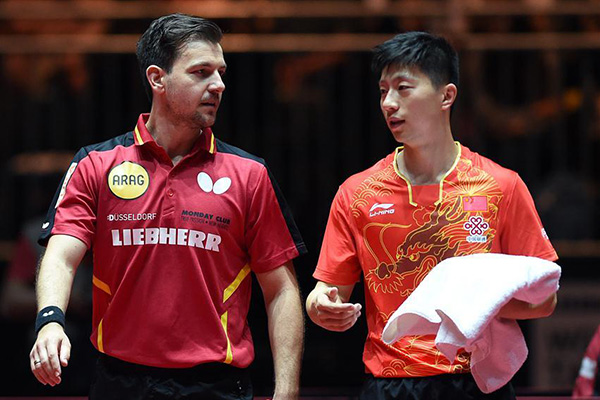 File photo shows China's Ma Long (R) and Germany's Timo Boll react before the men's doubles round of 64 match against Tamas Lakatos and Krisztian Nagy of Hungary at the 2017 World Table Tennis Championships in Dusseldorf, Germany, on May 30, 2017. Ma Long and Timo Boll won 4-0. (Photo/Xinhua)