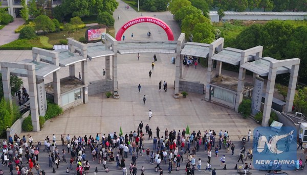 Students shake hands with their teachers after finishing their first subject of the examination in Beijing on June 7, 2017. (Xinhua/Wang Huajuan)