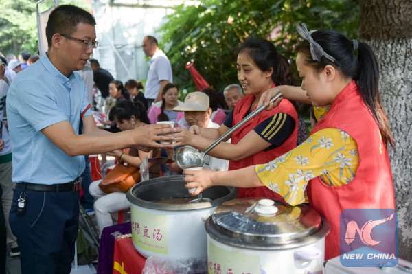 Students go through security and anti-cheating check before taking the exam in Jilin Province on June 7, 2017. (Xinhua/Meng Delong)