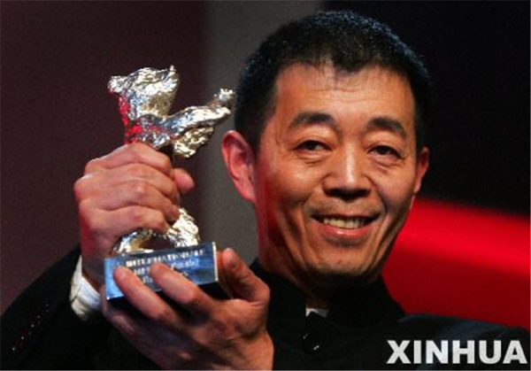 Film director Gu Changwei shows the Jury Grand Prix-Silver Bear awarded for his film Peacock at the 2005 Berlin International Film Festival. [Photo/Xinhua]