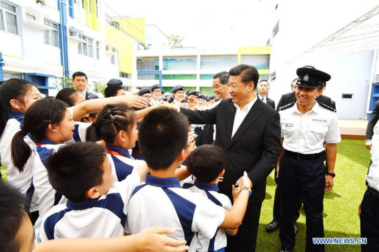 Chinese President Xi Jinping shakes hands with Junior Police Call (JPC) members when visiting the JPC Permanent Activity Center and Integrated Youth Training Camp in Hong Kong, south China, June 30, 2017. (Xinhua/Li Tao)