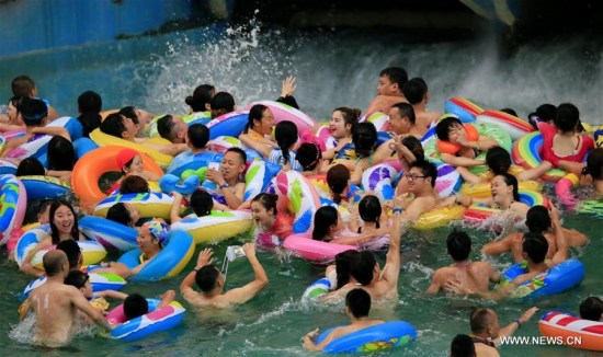 People play water and enjoy coolness at a tourism zone in Daying County of Suining, southwest China's Sichuan Province, July 4, 2017. (Xinhua/Zhong Min)