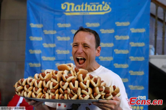 Current world record holder Joey Chestnut poses with a plate of hot dogs during the official weigh-in ceremony for the Nathan's Famous Fourth of July International Hot Dog Eating Contest in Brooklyn, New York City, U.S., July 3, 2017. (Photo/Agencies)