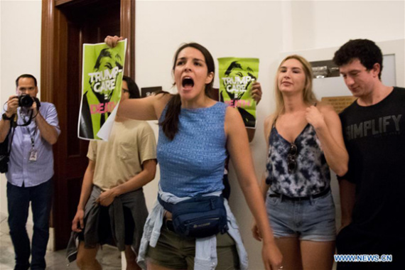 People participate in a protest against Republican health care bill in Russell Senate Office Building on Capitol Hill in Washington D.C., the United States, July 10, 2017. (Xinhua/Ting Shen)