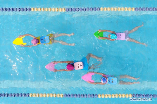 Children cool off in a swimming pool in Xingtai City, north China's Hebei Province, July 2, 2017. (Xinhua/Chen Lei)