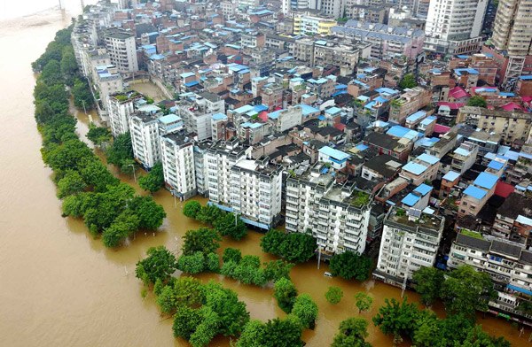 Floodwaters from the Liujiang River soak part of Liuzhou in the Guangxi Zhuang autonomous region on Tuesday. It was the third flood in the city since June 29. (Photo by Li Hanchi/For China Daily)