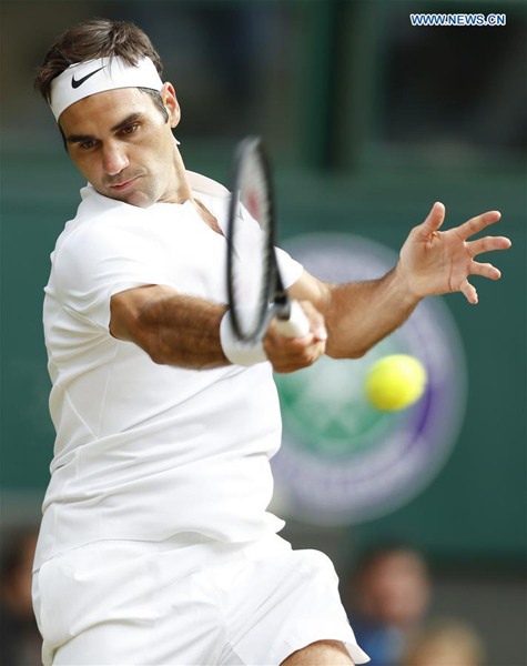 Roger Federer of Switzerland returns the ball during the men's singles semifinal match with Tomas Berdych of the Czech Republic at the Championship Wimbledon 2017 in London, Britain on July 14, 2017. Roger Federer won 3-0. (Xinhua/Han Yan)
