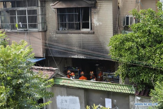 Rescuers work at the site of a house fire in Changshu, east China's Jiangsu Province, July 16, 2017. Police in Jiangsu said they have arrested a suspect for alleged arson after a fire engulfed a house that claimed 22 lives Sunday morning. (Xinhua/Ji Chunpeng)