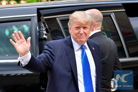 U.S. President Donald Trump waves as he arrives at the Elysees Palace in Paris, France, on July 13, 2017. (Xinhua File Photo/Chen Yichen)
