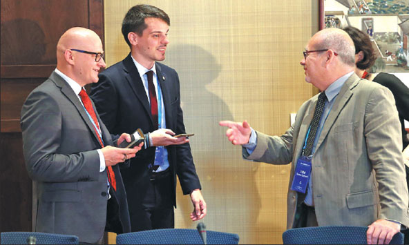 Roman Zamboch (right), director of the press office of the Chamber of Deputies of the Parliament of the Czech Republic, speaks with other delegates at the China-CEEC Spokespersons Dialogue in Beijing on Monday.Wang Zhuangfei / China Daily