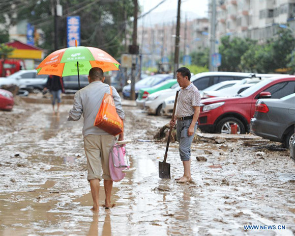 Citizens wade in the mud in Suide County of Yulin City, northwest China's Shaanxi Province, July 27, 2017. Torrential rain has battered the city of Yulin since Tuesday evening. In the worst-hit Suide and Zizhou counties, precipitation from 8 a.m. Tuesday to 7 a.m. Wednesday exceeded 200 millimeters, according to the provincial flood control headquarters. (Xinhua/Zhang Bowen)