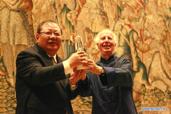 Chinese poet Jidi Majia (L), vice-president of the China Writers Association, is awarded Lifetime Achievement Prize of Silver Willow during the third Cambridge Xu Zhimo Poetry Art Festival at the Cambridge University's King's College in Cambridge, Britain, July 29, 2017. (Xinhua/Tang Chao)