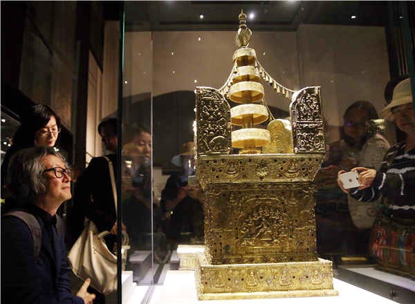 Splendor and Beauty: The Archaeological Finds in Recent 20 Years in China displays 360 sets of artifacts unearthed from around the country. A model of the Ashoka Pagoda is one of the biggest draws at the show. (Photo by Jiang Dong/China Daily)