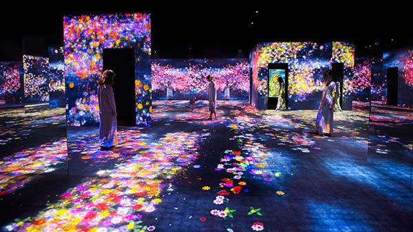 Visitors experience the interactive digital installations at the show teamLab: Living Digital Forest and Future Park in Beijing. (Photo Provided to China Daily)