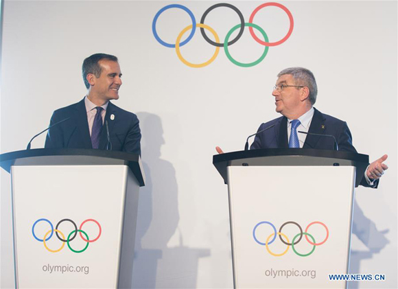 Mayor of Los Angeles Eric Garcetti (L) communicates with International Olympic Committee (IOC) President Thomas Bach at Olympic Museum in Lausanne, Switzerland, July 10, 2017. Members of IOC will hold a session for presentations by the campaign teams for Los Angeles and Paris on July 11th and 12th. (Xinhua file photo/Xu Jinquan)