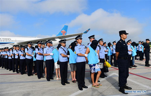 Suspects in telecom and online fraud cases are brought back to China from Fiji at Changchun Longjia International Airport, Changchun, northeast China's Jilin Province, Aug. 5, 2017. A total of 77 suspects in telecom and online fraud cases have been brought back to China from Fiji, the Ministry of Public Security announced Saturday. The suspects are accused in more than 50 cases involving more than 6 million yuan (892,000 U.S. dollars). (Xinhua/Lin Hong)