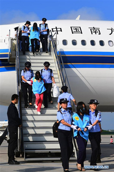 Suspects in telecom and online fraud cases are brought back to China from Fiji at Changchun Longjia International Airport, Changchun, northeast China's Jilin Province, Aug. 5, 2017. A total of 77 suspects in telecom and online fraud cases have been brought back to China from Fiji, the Ministry of Public Security announced Saturday. The suspects are accused in more than 50 cases involving more than 6 million yuan (892,000 U.S. dollars). (Xinhua/Lin Hong)