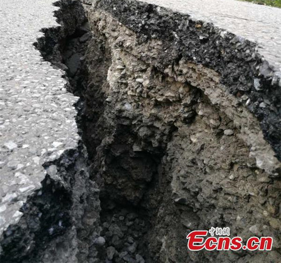 A road is cracked after an earthquake in Jiuzhaigou County, Southwest Chinas Sichuan Province, Aug. 9, 2017. At least 13 people were killed and 175 injured after the earthquake jolted Jiuzhaigou County at 9.19pm. (Photo: China News Service/Feng Zheng)