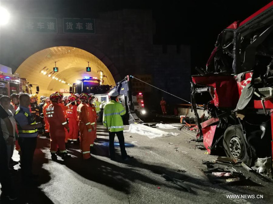 Rescuers work at the accident site after a coach hit the wall of the Qinling Mountains No. 1 Tunnel on the Jingkun Expressway in Ningshan County, northwest China's Shaanxi Province, Aug. 11, 2017. (Xinhua)