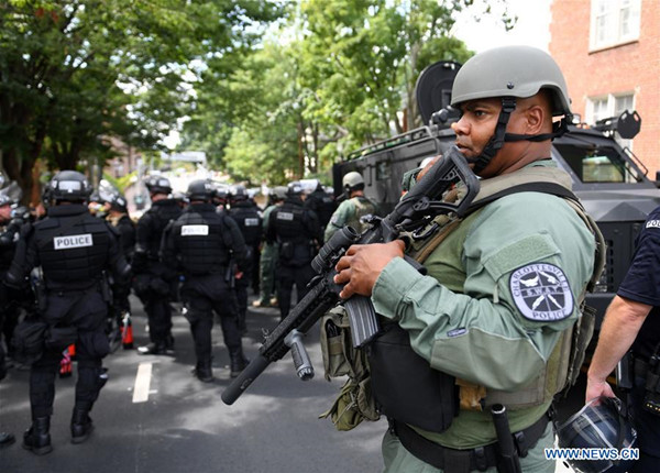 Police stand guard near the rally site in Charlottesville, Virginia, the United States, Aug. 12, 2017. At least one person was killed in a multiple car crash following a violent white nationalist rally on Saturday in Charlottesville in Virginia, Charlottesville Mayor Michael Signer said. (Xinhua/Yin Bogu)