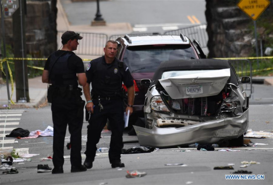 Police work at the car crash site following a violent white nationalist rally in Charlottesville, Virginia, the United States, Aug. 12, 2017. (Photo: Xinhua/Yin Bogu)