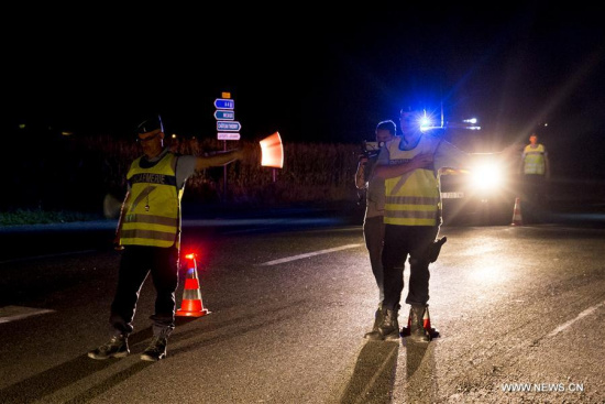 Security forces stand guard near the site where a car crashed into the outdoor terrace of a pizzeria at Sept-Sorts, northeast of Paris, France, on Aug. 14, 2017.  (Xinhua/Thel Duval)