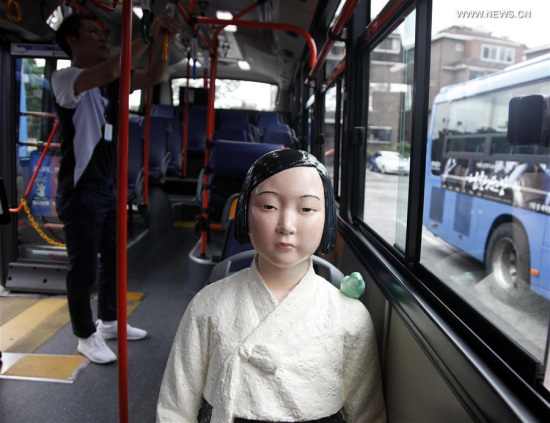 A comfort women statue is seen on a bus in Seoul, South Korea, Aug. 13, 2017. Five buses installed with comfort women statues will be put into operation from Aug.14 to Sept. 30 to commemorate the ladies who were used as sexual slaves during the Second World War and remind people of that very history. (Xinhua/Yao Qilin)