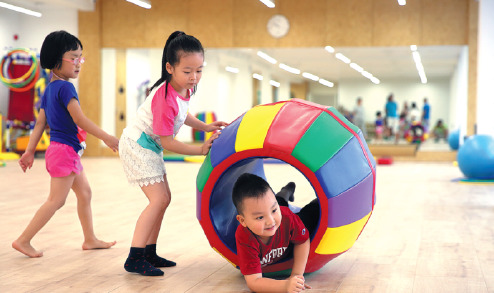 Students play games at a kindergarten in Beijing. 