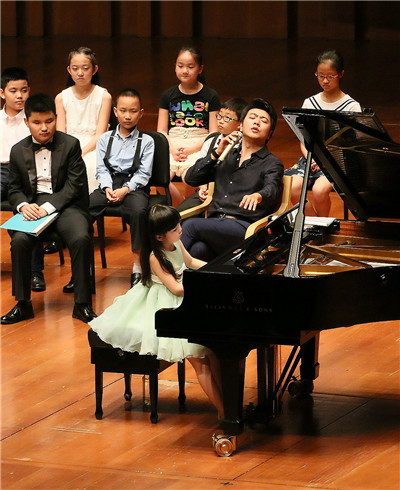 Lang Lang gives instructions to young musicians at an open master class on Monday at the National Center for the Performing Arts in Beijing. Lang Lang, pianist.