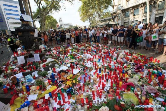 Toys, flowers and candles are placed on the avenue to mourn for victims in the terrorist attacks in the Las Ramblas area of Barcelona, Spain, Aug. 19, 2017. (Xinhua/Xu Jinquan)