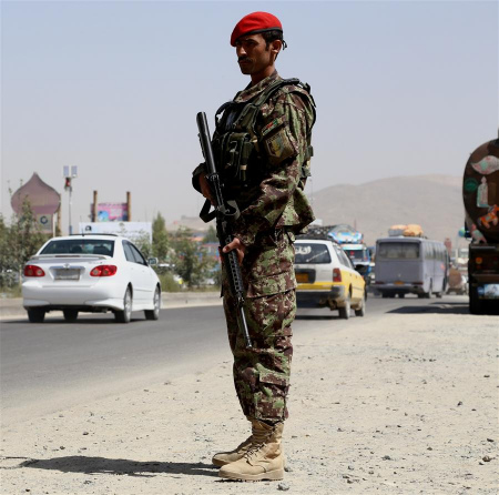 An Afghan security force member stands guard at a security checkpoint in Ghazni province, eastern Afghanistan, Aug. 22, 2017. The Afghan Taliban on Tuesday said that the insurgents will continue the war against U.S. and its allies until the U.S.-led forces leave Afghanistan. (Xinhua/Sayed Mominzadah)