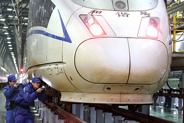 Technicians inspect bullet trains in Shanghai. China's new-generation bullet train, the Fuxing, will make seven round trips each day between Beijing and Shanghai from Sept 21 at 350 kph. (Photo/Xinhua)
