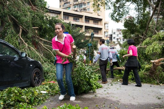 Volunteers of Women's General Association of Macao clean a road in Macao, south China, Aug. 24, 2017. Bringing heavy gusts and rainstorms, Hato destroyed more than 4,000 trees in Macao on Wednesday. (Xinhua)