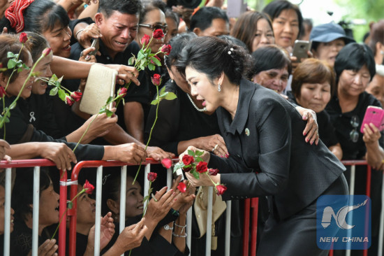 Supporters present flowers to Former Thai prime minister Yingluck Shinawatra upon her arrival at the Thai Supreme Court in Bangkok, Thailand, July 21, 2017. (Xinhua/Li Mangmang)