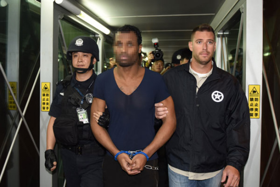 Chinese police hand over fugitive Naquan Ferguson to police from the United States in Guangzhou on Friday. LU HANXIN/XINHUA