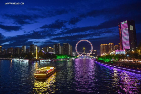 Photo taken on Aug. 25, 2017 shows the night scene of the Tianjin Eye in north China's Tianjin Municipality. The 13th Chinese National Games will open on Aug. 27 in Tianjin. (Xinhua/Li Bo)