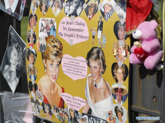 Tributes of photographs and flowers are placed at the Gate of Kensington Palace on the 20th anniversary of the death of Princess Diana in London, Britain on Aug. 31, 2017. (Xinhua/Han Yan)