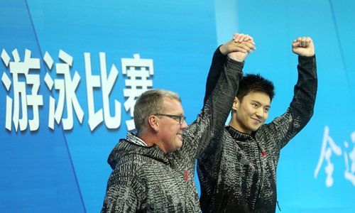 Swimmer Ning Zetao (right) celebrates winning the men's 100-meter freestyle at the Chinese National Games on Monday in Tianjin. (Photo: Cui Meng/GT)