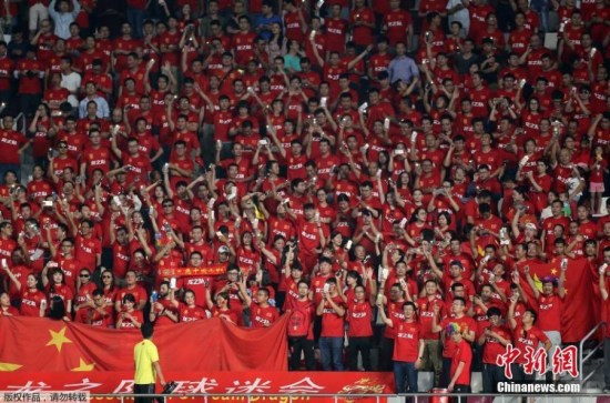 Fans cheer on Chinas players during the FIFA World Cup 2018 qualification football match against Qatar at the Jassim Bin Hamed Stadium in Doha, Sept. 5, 2017. China defeated Qatar 2-1 in the match, but failed to earn a WC finals ticket. (Photo/Agencies)