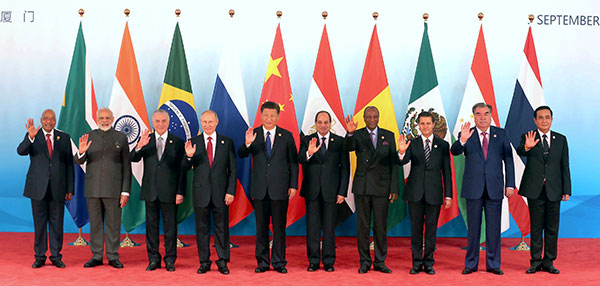 President Xi Jinping (center) stands with other leaders in Xiamen, Fujian province, on Tuesday before the Dialogue of Emerging Market and Developing Countries. The other leaders are, from left, South African President Jacob Zuma, Indian Prime Minister Narendra Modi, Brazilian President Michel Temer, Russian President Vladimir Putin, Egyptian President Abdel-Fattah al-Sisi, Guinean President Alpha Conde, Mexican President Enrique Pena Nieto, Tajikistan President Emomali Rahmon and Thai Prime Minister Prayut Chan-o-cha.(Wu Zhiyi/China Daily)