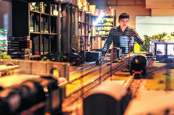 A returnee from the U.S. displays model trains he sells on his online store in Shanghai. NIU JING / FOR CHINA DAILY