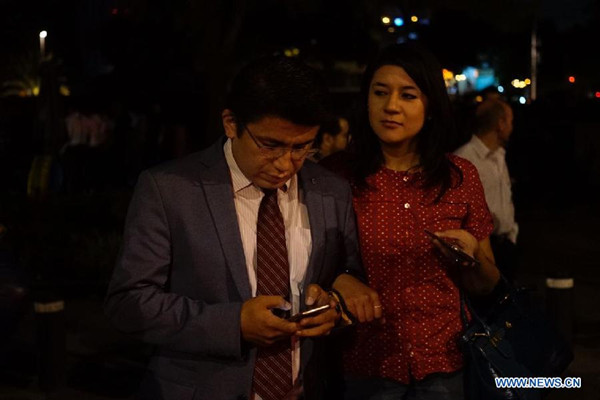 People react on a street after an earthquake jolted Mexico City, capital of Mexico, on Sept. 8, 2017. An earthquake measuring 8.2 on the Richter scale hit off the coast of Chiapas State of Mexico at 12:49 p.m. Beijing time on Friday, according to preliminary reports from the China Earthquake Networks Center. (Xinhua/David de la Paz)