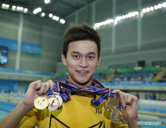 Sun Yang of Zhejiang shows all his medals after the awarding ceremony of men's 4x100m medley relay final at 13th Chinese National Games in north China's Tianjin Municipality, Sept. 7, 2017. Sun Yang won six gold medals and one silver medal at 13th Chinese National Games. (Xinhua/Fei Maohua)