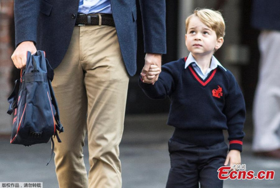 Prince George holds his father Britain's Prince William's hand as he arrives on his first day of school at Thomas's school in Battersea, London, September 7, 2017. (Photo/Agencies) 