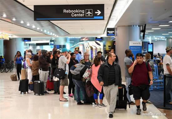 Passengers queue to rebook their flights which have been canceled due to the effect of hurricane Irma at Miami International Airport in Miami, Florida, the United States, on Sept. 8, 2017. (Xinhua/Yin Bogu)