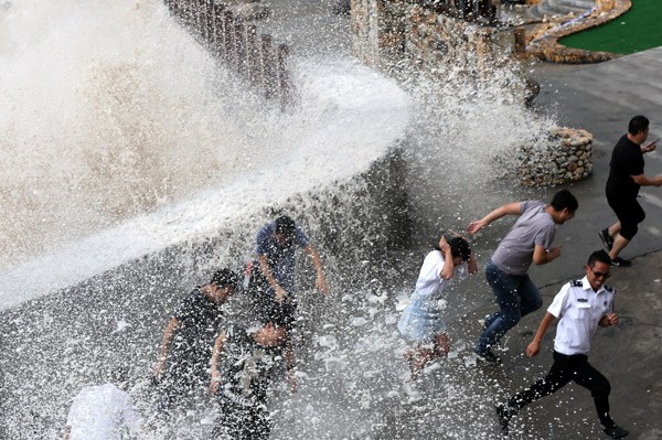 A wave crashes into a barrier in Wenling, Zhejiang province, on Thursday ahead of Typhoon Talim. (Photo by LI HUHU/CHINA DAILY)