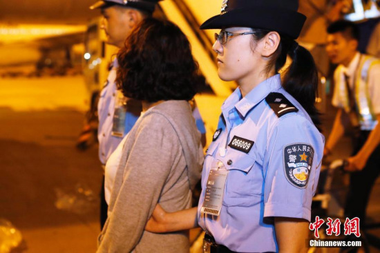 Min (C) is escorted at airport in Shanghai on Sept 19, 2017. (Photo: China News Service/Yin Liqin)